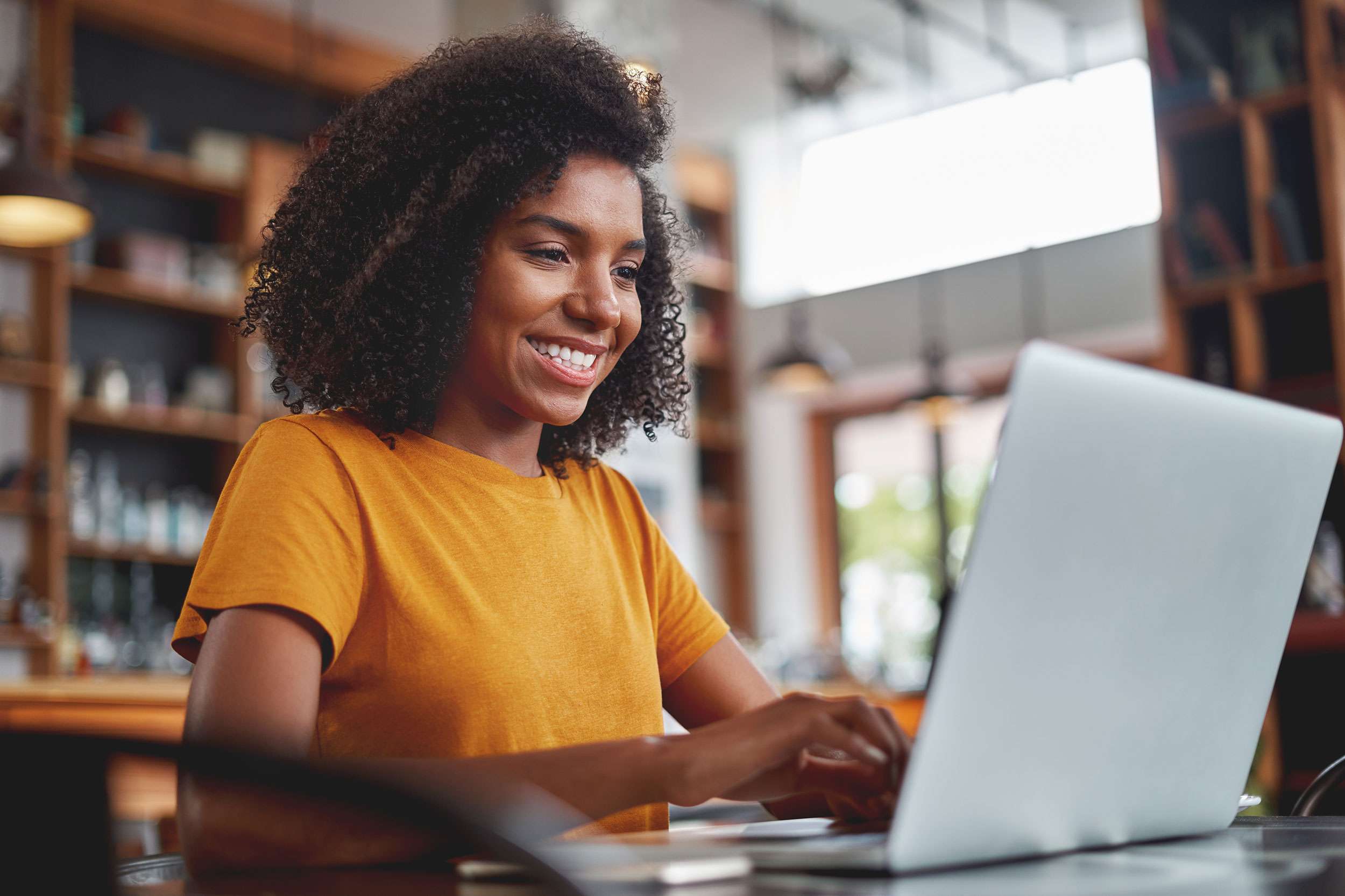 photo of a young woman working on her website using wordpress: the best content management system as of 2024