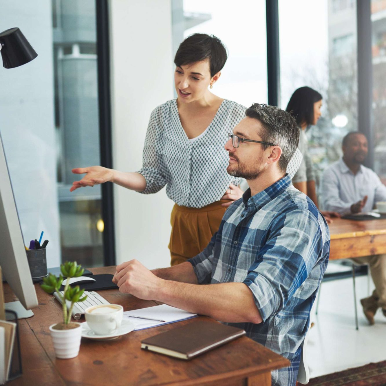 photo of two colleagues working on to implement different types of SEO for their business.